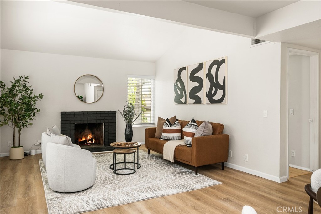 1420 E Cabrillo Park Drive, Unit E Santa Ana, CA 92701 - Photo 17 of 46 a living room with furniture and a fireplace