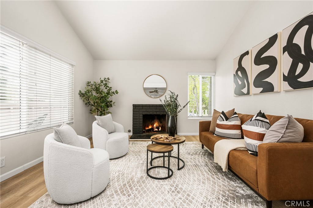 1420 E Cabrillo Park Drive, Unit E Santa Ana, CA 92701 - Photo 19 of 46 a living room with furniture a fireplace and potted plants