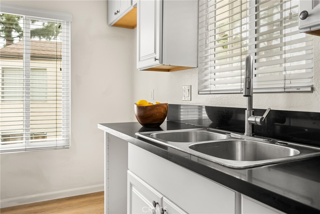 1420 E Cabrillo Park Drive, Unit E Santa Ana, CA 92701 - Photo 25 of 46 a kitchen with a sink and a window