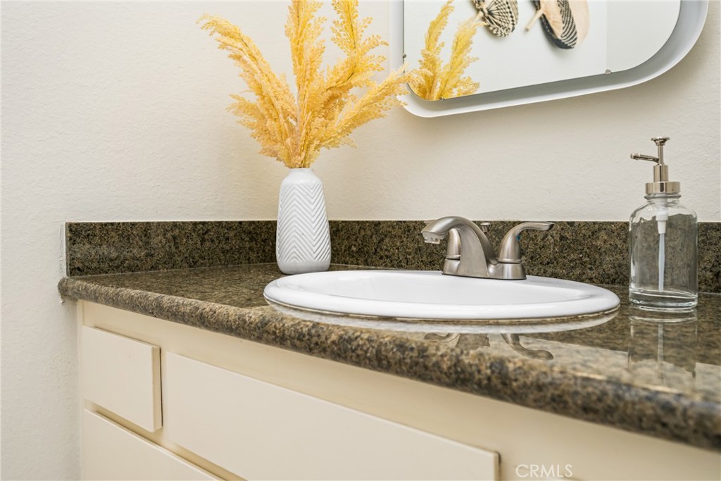 1420 E Cabrillo Park Drive, Unit E Santa Ana, CA 92701 - Photo 37 of 46 a bathroom with a sink and a mirror