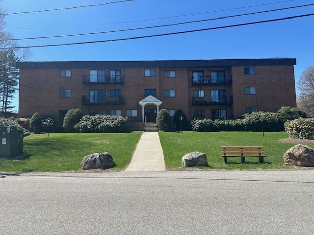 181 Littleton Road, Unit 236 Chelmsford, MA 01824 - Photo 1 of 14 a view of a house with a yard and plants