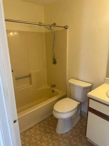 181 Littleton Road, Unit 236 Chelmsford, MA 01824 - Photo 11 of 14 a white toilet sitting next to a bath tub