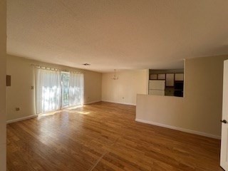 181 Littleton Road, Unit 236 Chelmsford, MA 01824 - Photo 2 of 14 a view of an empty room with wooden floor and a window