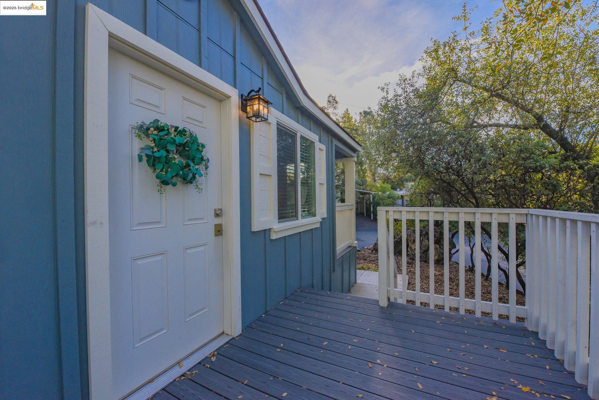 10956 Green Street Columbia, CA 95310 - Photo 1 of 45 Doorway to property featuring board and batten siding and a wooden deck