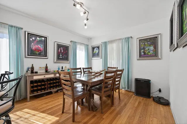 a view of a dining room with furniture and wooden floor