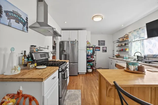 a kitchen with refrigerator and cabinets