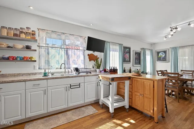 a open kitchen with sink cabinets and wooden floor