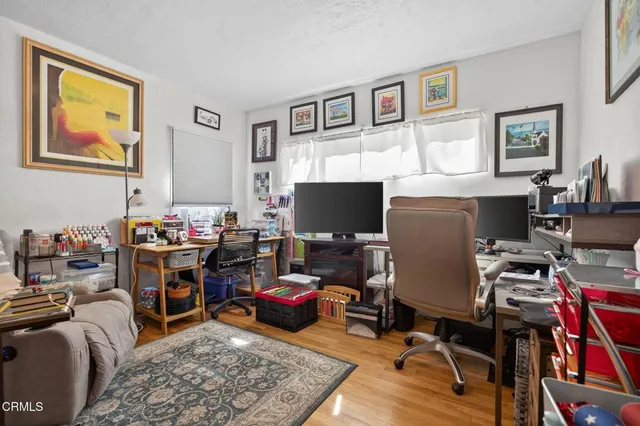 a view of a livingroom with workspace and a couch