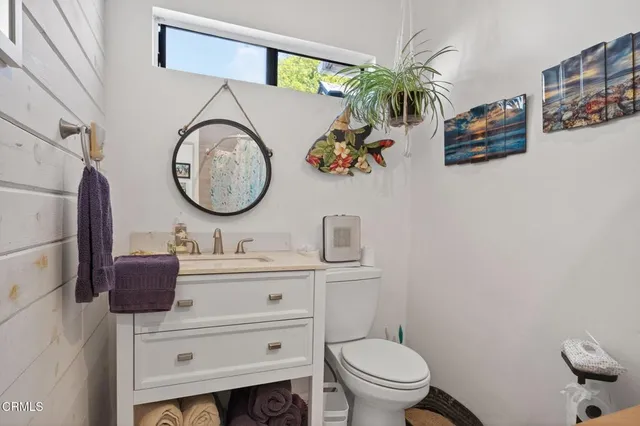 a bathroom with a toilet a sink and a mirror