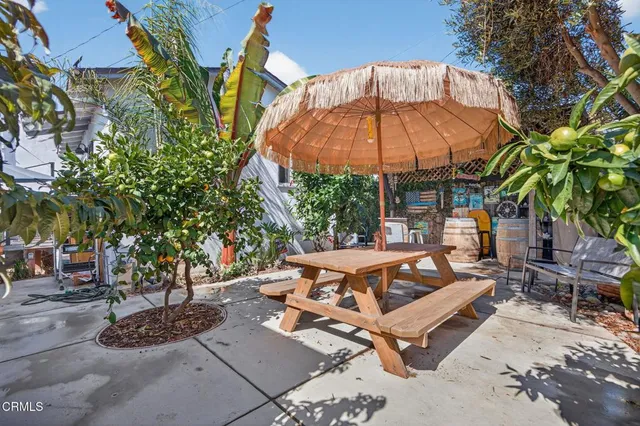 a view of backyard with outdoor seating and trees