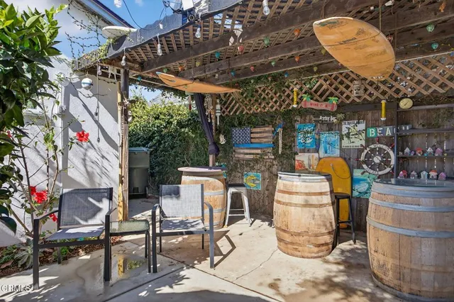 a patio with glass top table and chairs