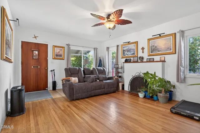 a living room with furniture a fireplace and a window