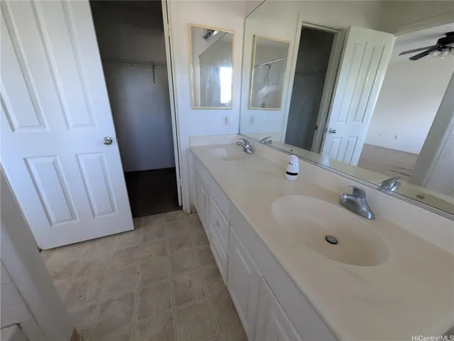 a bathroom with a sink a tub and a mirror