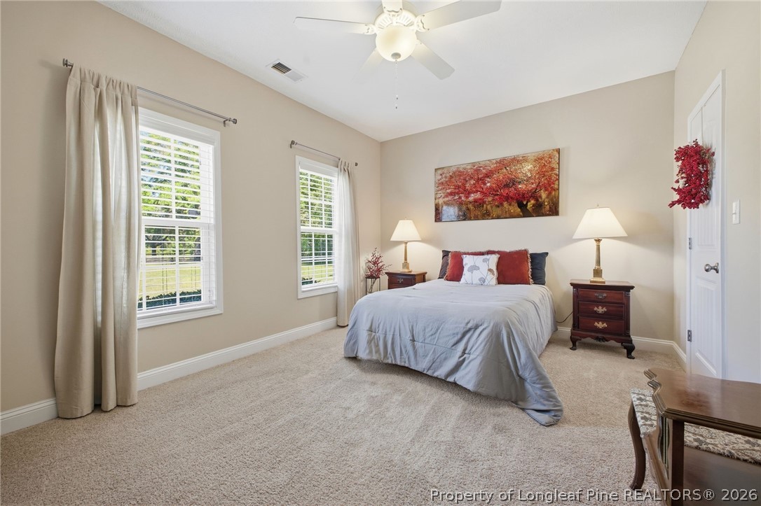 2589 June Johnson Road Raeford, NC 28376 - Photo 28 of 49 a bedroom with a large bed and a chandelier