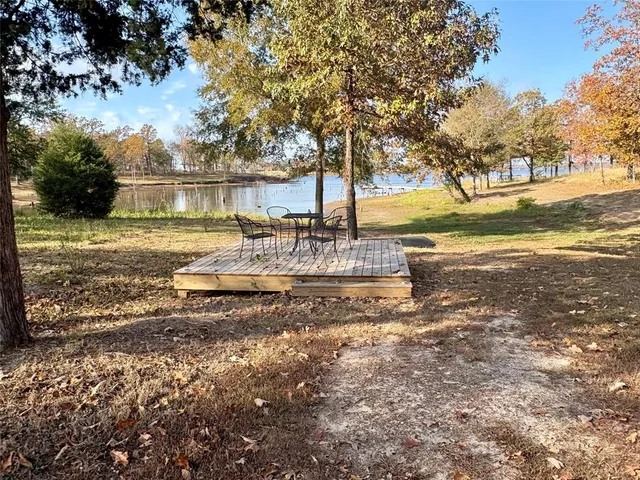 a view of a house with a yard and sitting area