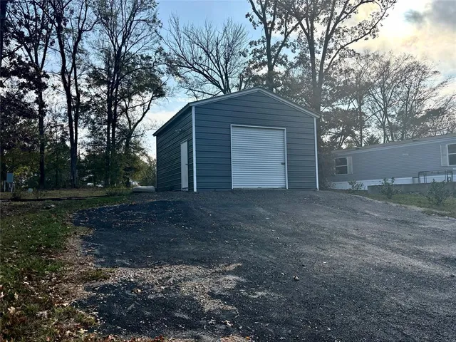 a view of a house with a yard and garage
