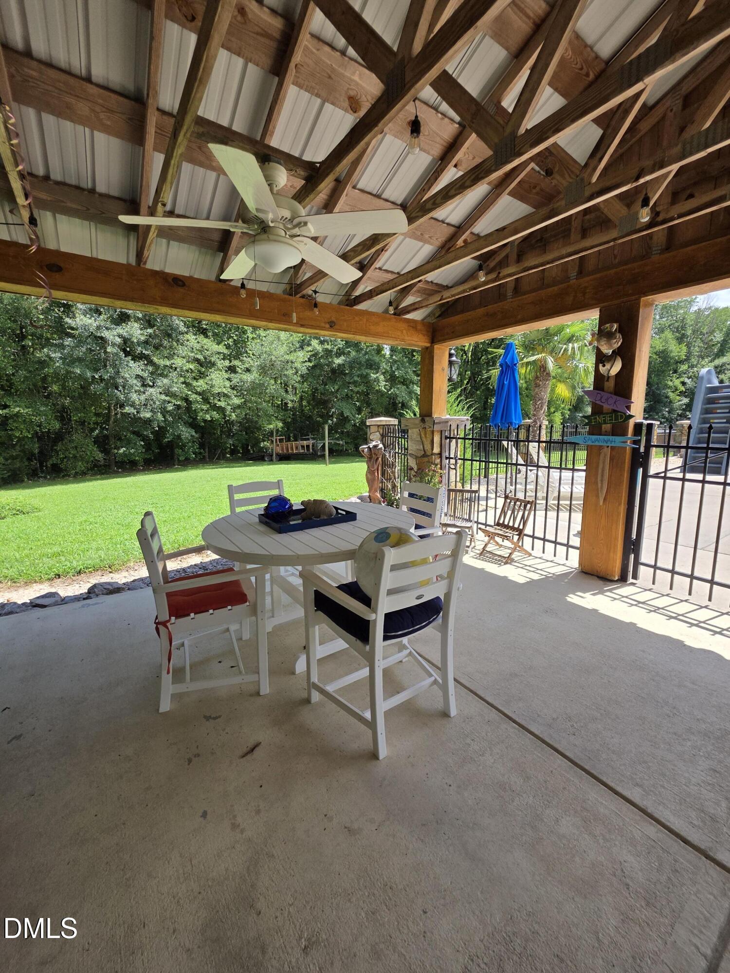 413 Johnson Town Road Zebulon, NC 27597 - Photo 37 of 42 a view of a patio with a table and chairs