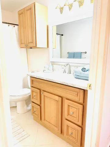 a bathroom with a sink toilet and mirror
