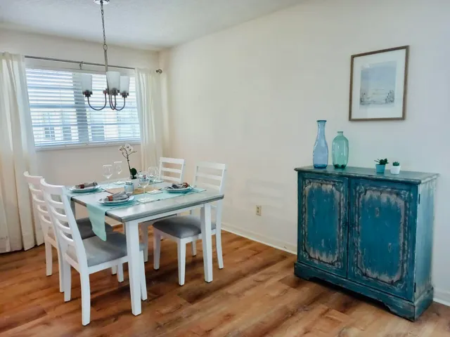 a dining room with furniture and wooden floor