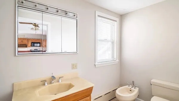 a bathroom with a sink a mirror and a toilet