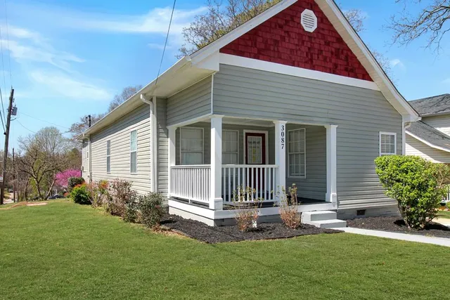 a front view of a house with a garden
