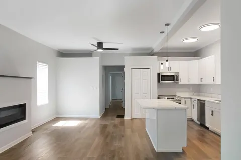 a open kitchen with cabinets a sink and a stove