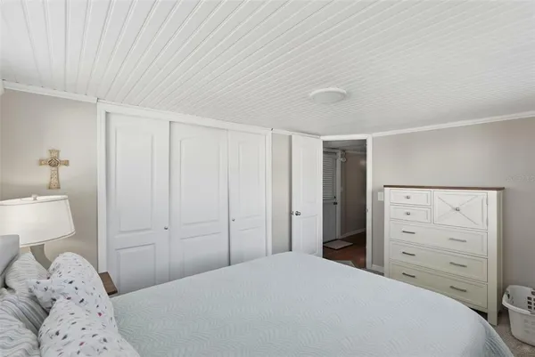 a bedroom with a bed and a dresser