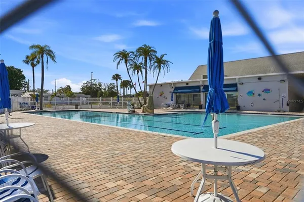 a view of a swimming pool with a table and chairs