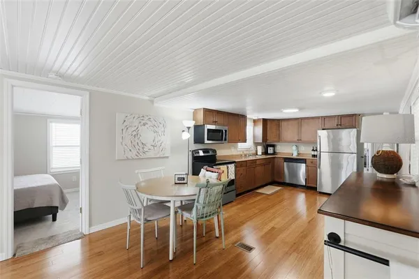 a kitchen with a dining table chairs and view living room