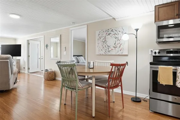 a view of a dining room with furniture and wooden floor