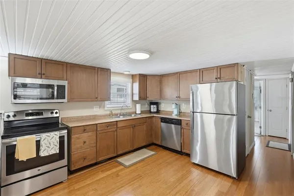 a kitchen with stainless steel appliances a refrigerator stove and microwave