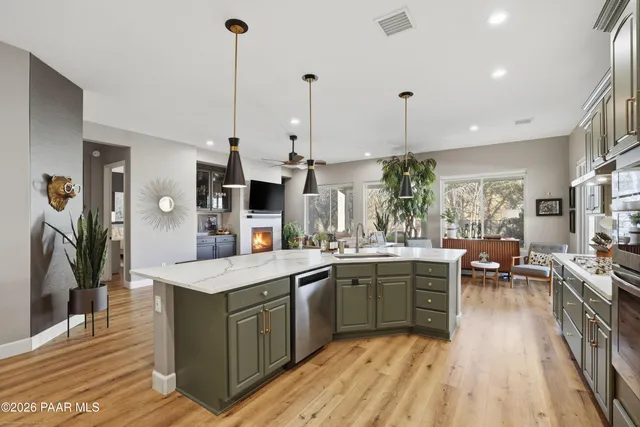 a kitchen with lots of counter space sink and living room view