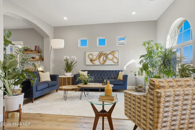 a living room with furniture and flowers