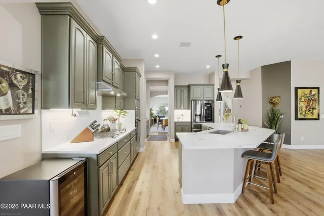 a kitchen with sink stove and cabinets