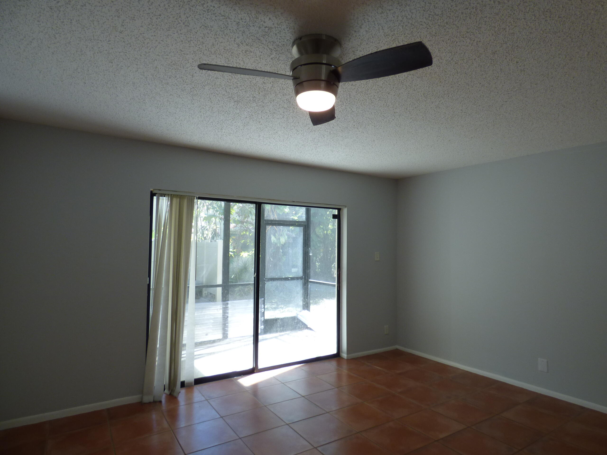 132 South Cypress Road, Unit 514 Pompano Beach, FL 33060 - Photo 17 of 48 an empty room with floor to ceiling windows