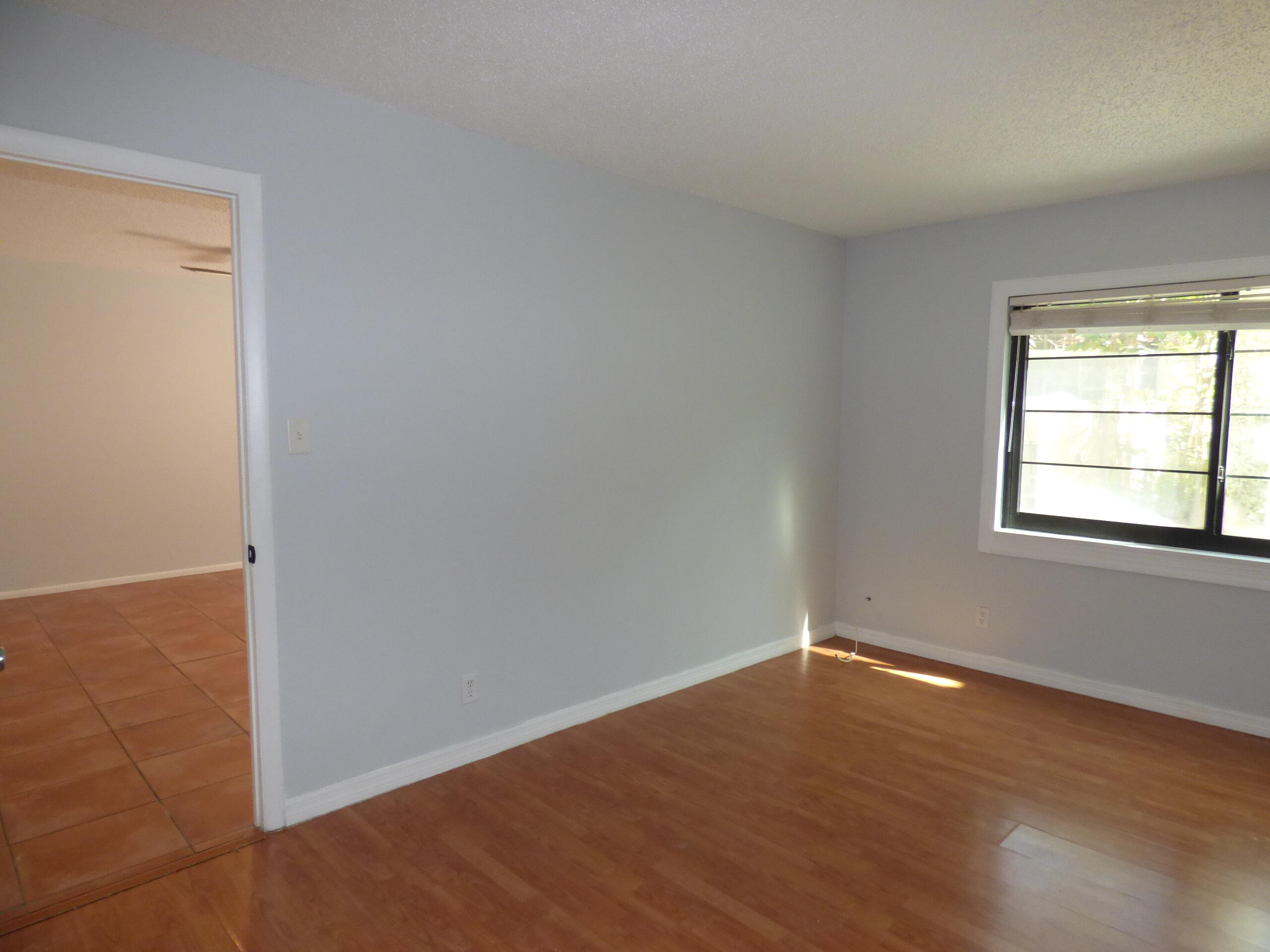 132 South Cypress Road, Unit 514 Pompano Beach, FL 33060 - Photo 25 of 48 an empty room with wooden floor and windows