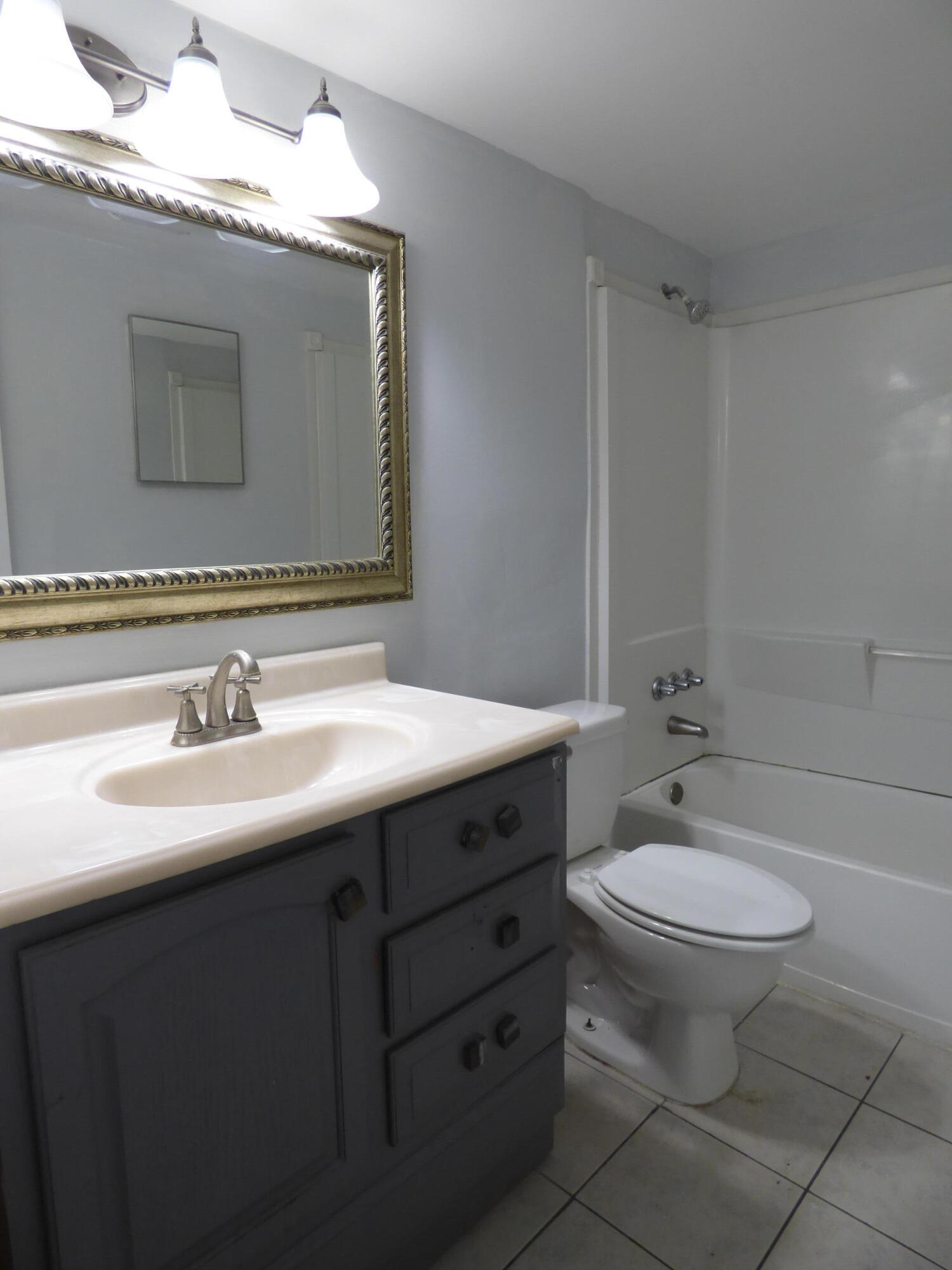 132 South Cypress Road, Unit 514 Pompano Beach, FL 33060 - Photo 31 of 48 a bathroom with a toilet sink and mirror
