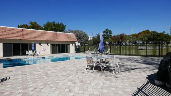 a view of house with a yard and sitting area