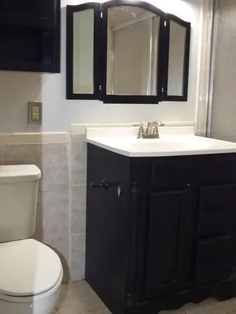 a bathroom with a sink vanity and a mirror