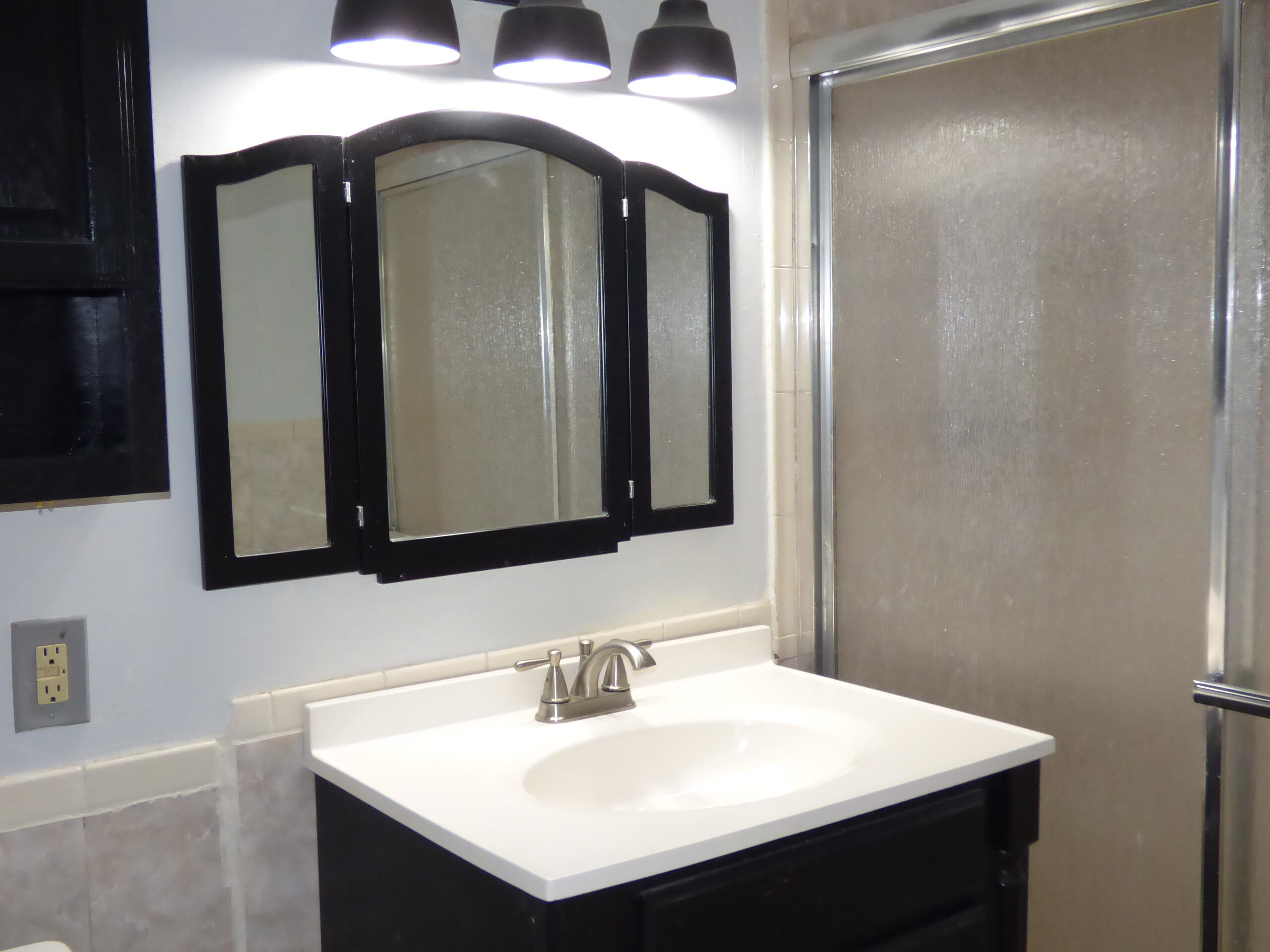 132 South Cypress Road, Unit 514 Pompano Beach, FL 33060 - Photo 8 of 48 a bathroom with a sink vanity and a mirror