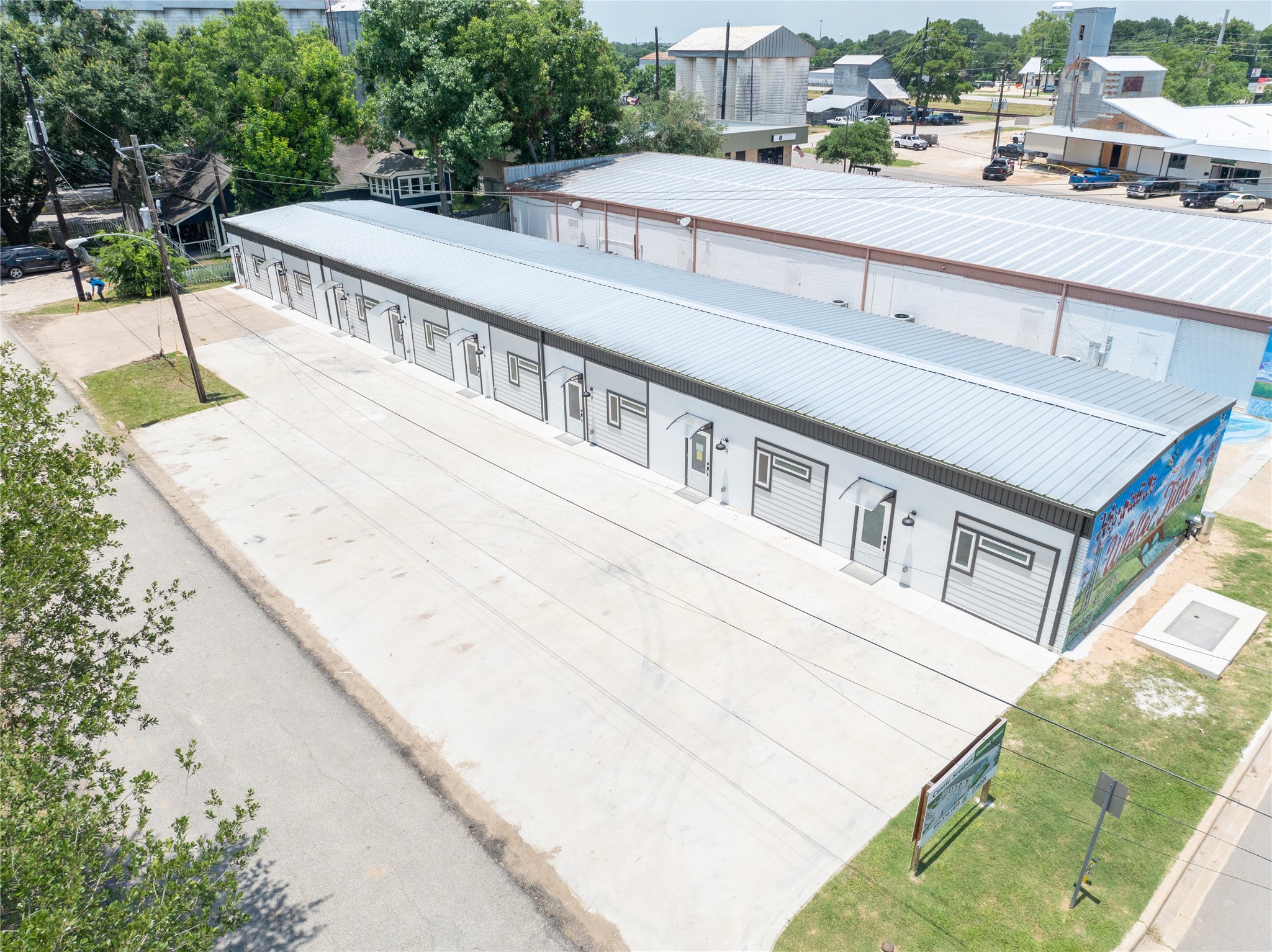 2612 Castle Street, Unit H Waller, TX 77484 - Photo 11 of 11 a view of a white building among the street and car parked