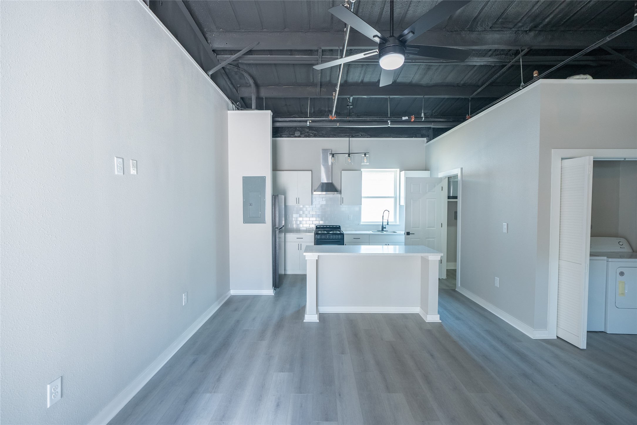 2612 Castle Street, Unit H Waller, TX 77484 - Photo 4 of 11 a view of a storage & utility room with wooden floor