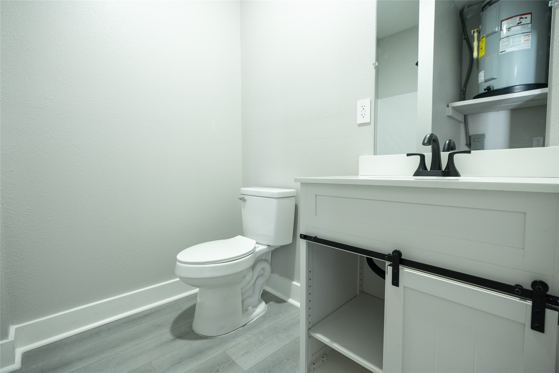 2612 Castle Street, Unit H Waller, TX 77484 - Photo 8 of 11 a bathroom with a toilet sink and mirror