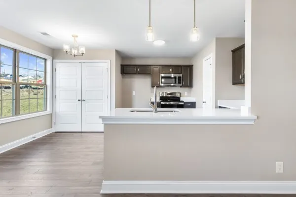 a kitchen with stainless steel appliances granite countertop a sink a stove and a refrigerator