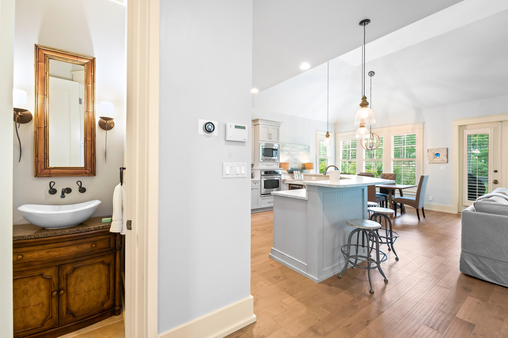 70 Pine Crest Circle Inlet Beach, FL 32461 - Photo 13 of 43 a room with stainless steel appliances kitchen island granite countertop a refrigerator a stove and a dining table with wooden floor