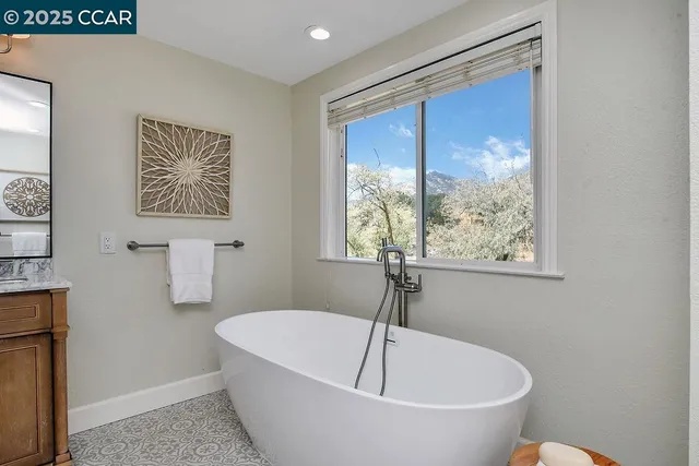 a bedroom with a bed and a potted plant