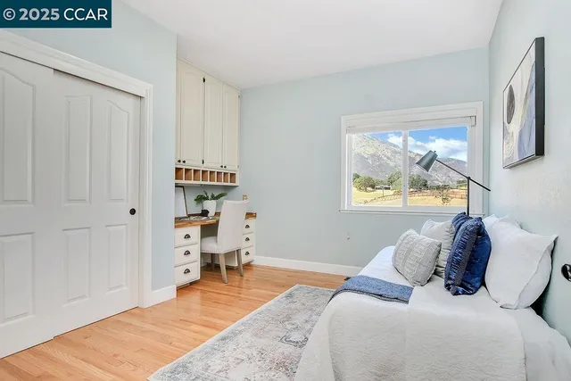 a bedroom with a bed and a window