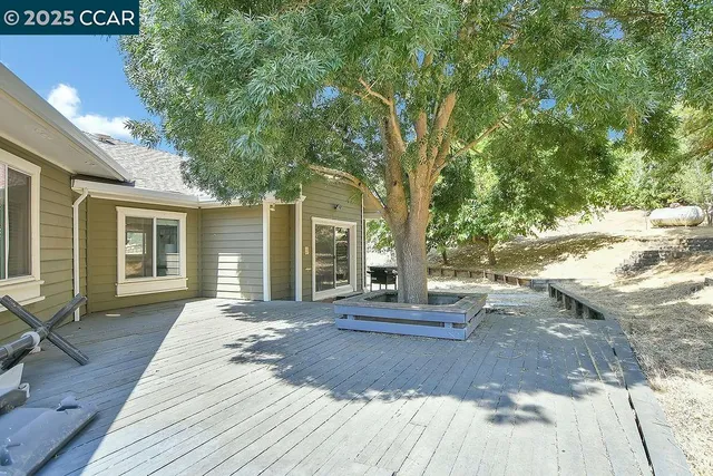 a view of a yard with wooden fence
