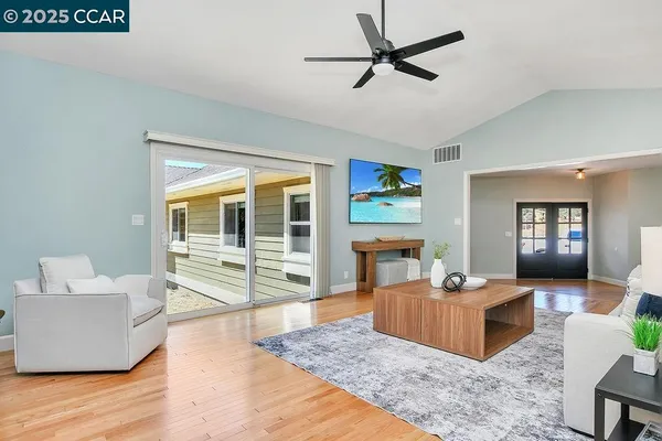 a kitchen with stainless steel appliances granite countertop a stove a white cabinets and a granite counter tops