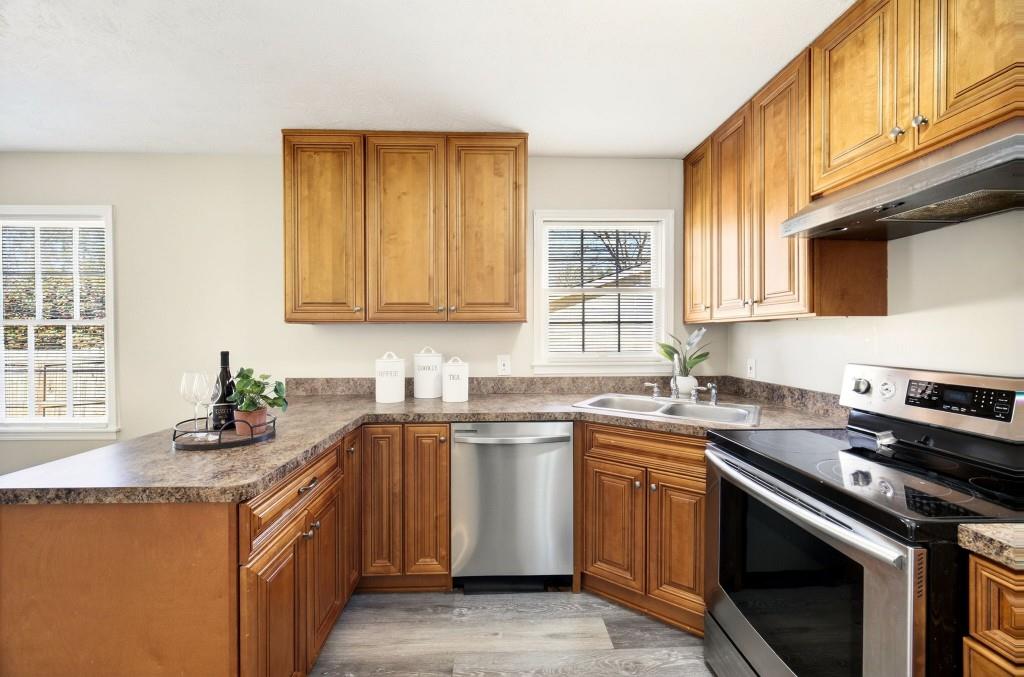 2545 Ridgecrest Drive Northwest Kennesaw, GA 30152 - Photo 11 of 20 a kitchen with stainless steel appliances granite countertop a sink stove and microwave
